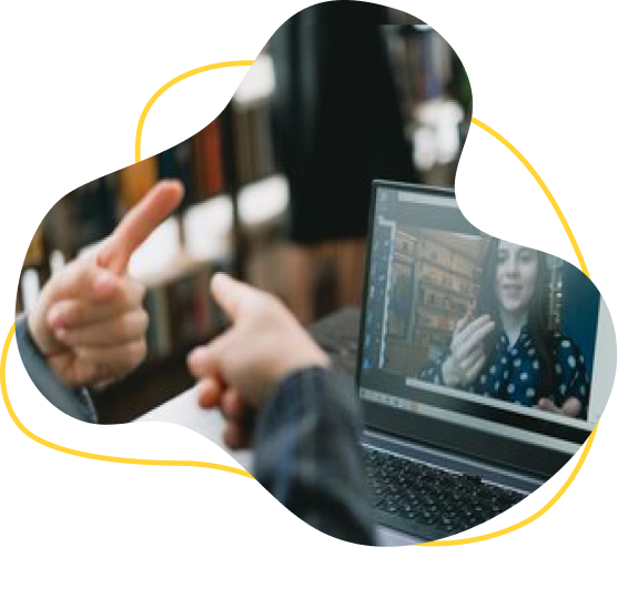 A pair of hands with the index finger raised using ASL with a person on a video call on a computer. The image is encased in a swirl border with a yellow line running through it.